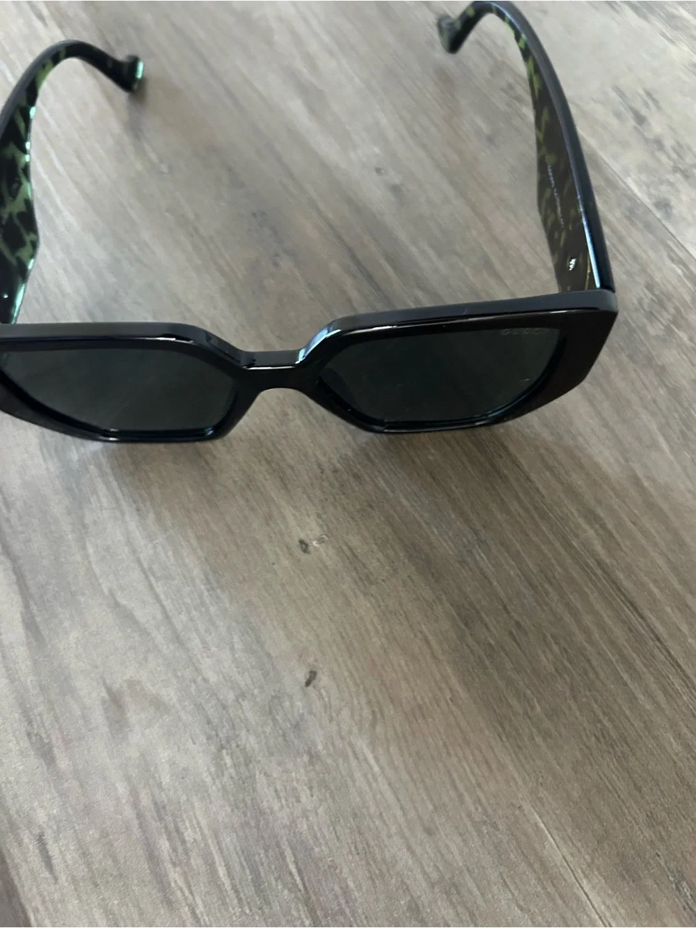 Black Cat-Eye Sunglasses with Green Lens and Temple Accents